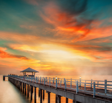 Hotel dock with hut at the end with beautiful sunset